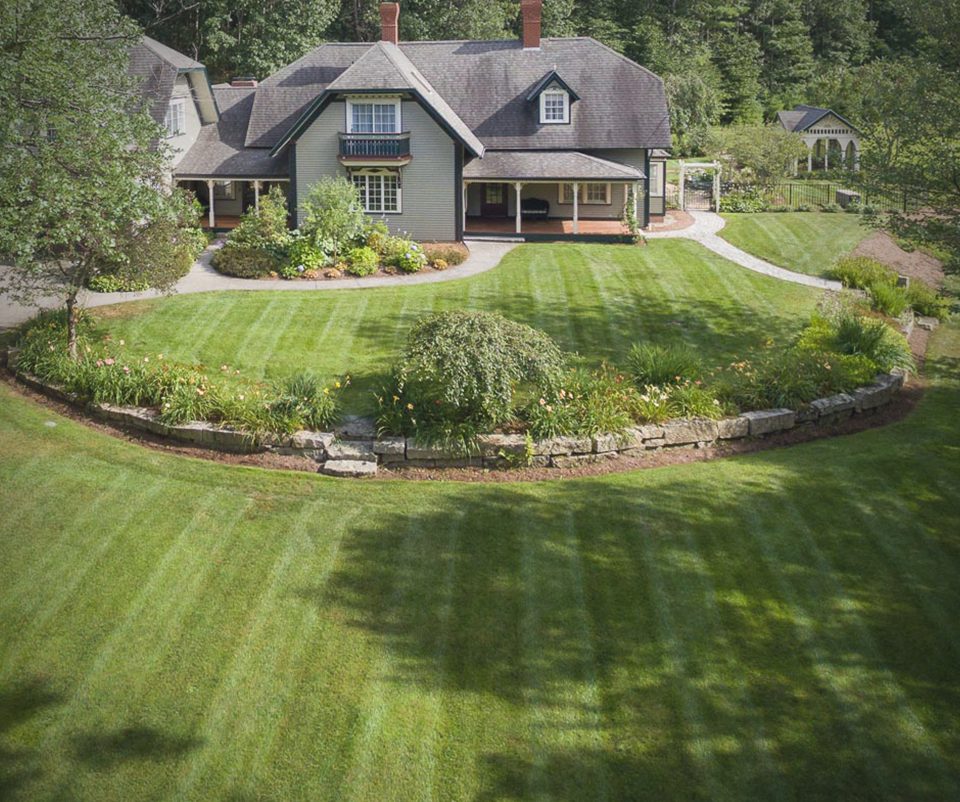 Estate lawn with curved stone-edged planting bed